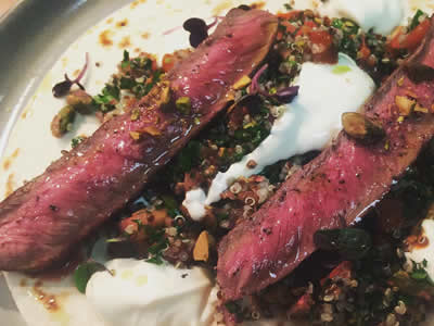 Spiced lamb loin pistachio quinoa tabouleh yoghurt flatbread.